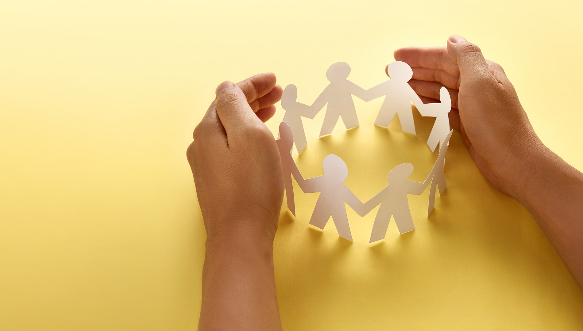 Block People Paper Paper people surrounded by hands in gesture of protection. Conce ...